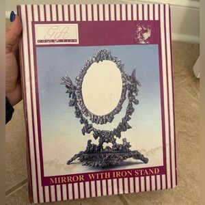 Vintage ornate Victorian-style iron swivel oval vanity mirror